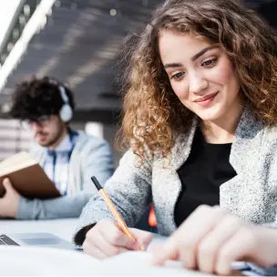 Picture of a student writing a thesis statement